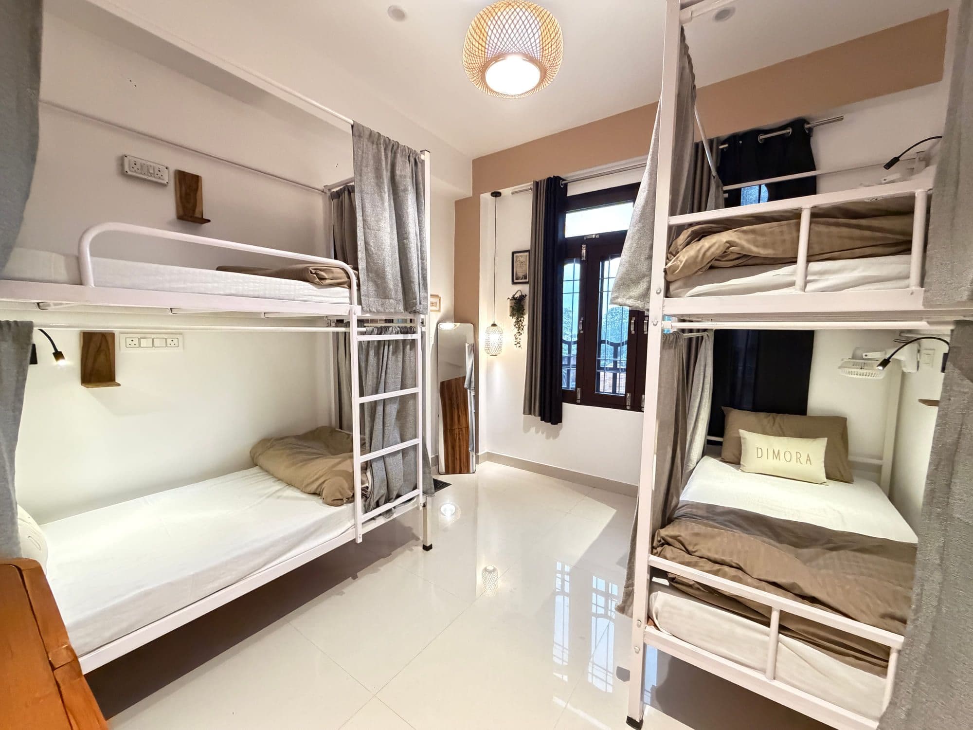 Dormitory at Dimora Homes, Bir - bunk beds with privacy curtains, reading lights and a window