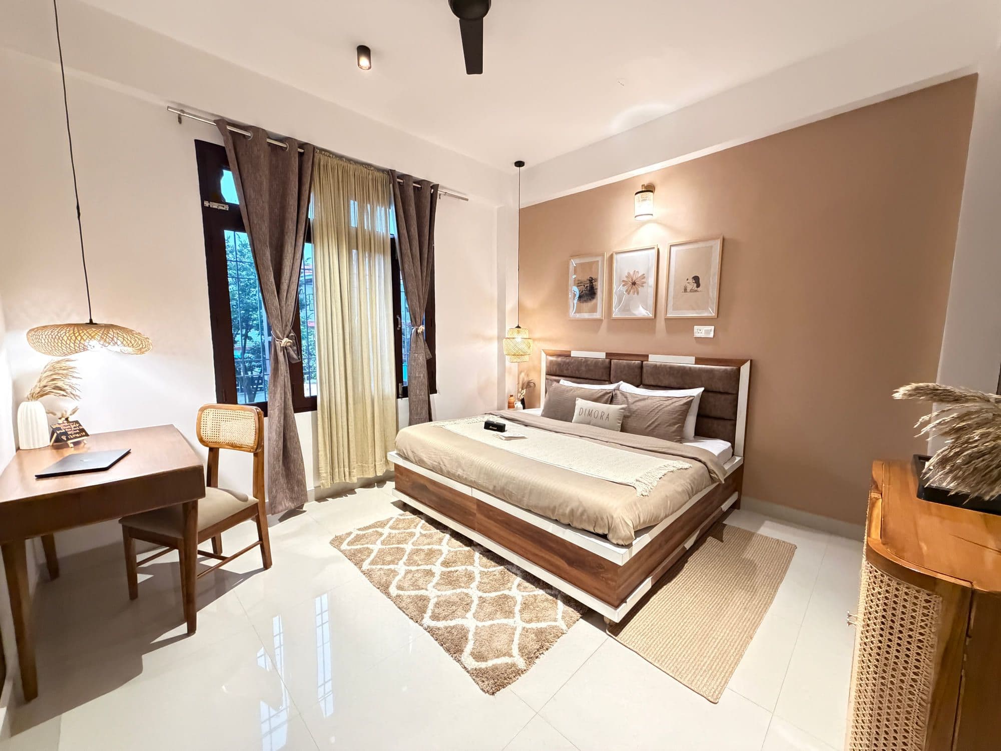 Deluxe room at Dimora Homes with a queen bed, writing desk, cane chair and mountain-facing window