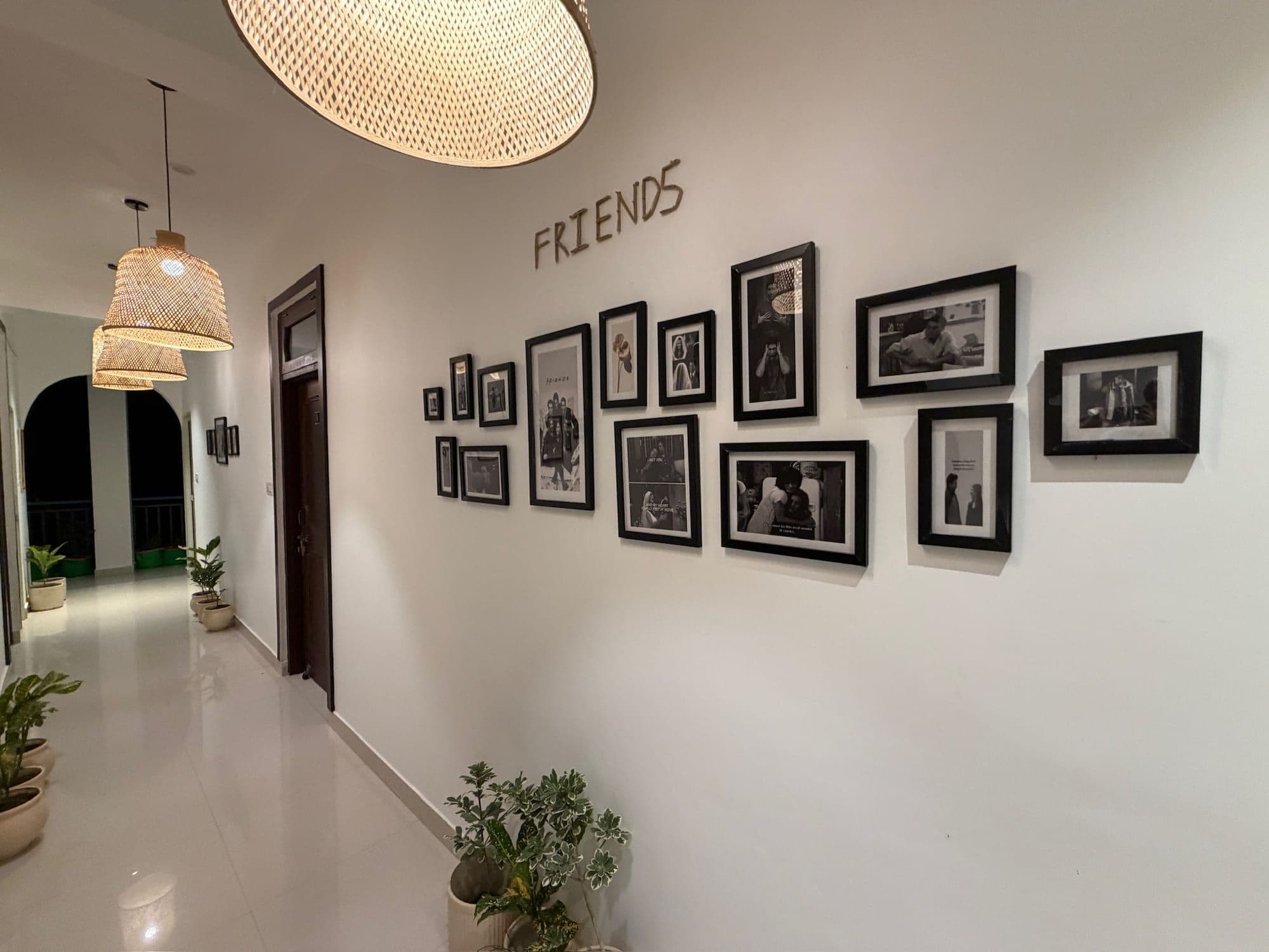Corridor wall spelling out the word FRIENDS above a cluster of framed black-and-white photographs
